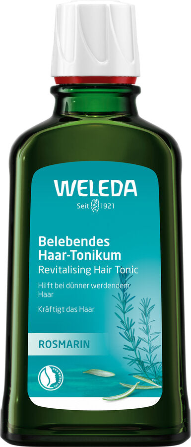 Das Bild zeigt eine Flasche des Weleda Belebenden Haar-Tonikums in Rosmarin. Die grüne Glasflasche hat einen weißen Deckel und zeigt prominent das Weleda-Logo. Das Etikett auf der Flasche ist auf Deutsch und beschreibt das Produkt als ein "Belebendes Haar-Tonikum", das bei dünner werdenden Haaren hilft und das Haar kräftigt.