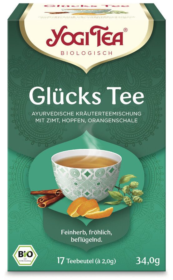 Eine Packung des 'Glücks Tee' von Yogi Tea. Die Verpackung ist grün und zeigt eine Illustration einer Tasse Tee mit einem geometrischen Muster, umgeben von Zimtstangen, Hopfen und Orangenschalen. Oben steht in roter Schrift 'Yogi Tea' und darunter 'Biologisch'. Die Teesorte ist als 'Ayurvedische Kräuterteemischung mit Zimt, Hopfen, Orangenschale' beschrieben. Unten steht 'Feinherb, fröhlich, beflügelnd'. Es sind 17 Teebeutel à 2,0 g enthalten, insgesamt 34,0 g. Unten links ist das Bio-Siegel abgebildet.