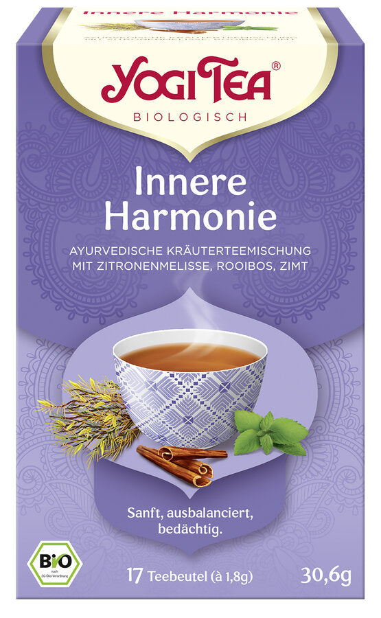 Eine Packung des 'Innere Harmonie' Tees von Yogi Tea. Die Verpackung ist lila und zeigt eine Illustration einer Tasse Tee mit einem geometrischen Muster, umgeben von Zitronenmelisse, Zimtstangen und Minzblättern. Oben steht in roter Schrift 'Yogi Tea' und darunter 'Biologisch'. Die Teesorte ist als 'Ayurvedische Kräuterteemischung mit Zitronenmelisse, Rooibos, Zimt' beschrieben. Unten steht 'Sanft, ausbalanciert, bedächtig'. Es sind 17 Teebeutel à 1,8 g enthalten, insgesamt 30,6 g.