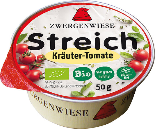 Das Bild zeigt eine runde, vegane Brotaufstrich-Dose der Marke Zwergenwiese. Die Dose hat einen roten Deckelrand und eine weiße Oberseite mit der Aufschrift "Zwergenwiese Streich Kräuter-Tomate". Unterhalb des Produktnamens stehen mehrere Symbole, die das Produkt als bio, vegan (hefefrei) und glutenfrei kennzeichnen. Die Nettofüllmenge beträgt 50 Gramm. Auf dem Deckel sind außerdem Abbildungen von Tomaten und Kräutern zu sehen. Das Markensymbol, ein roter Zwergenhut, ist ebenfalls auf dem Deckel abgebildet.