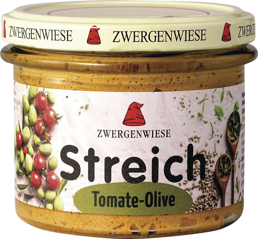 Ein Glas mit dem leckeren Bio-Aufstrich "Streich Tomate-Olive" von Zwergenwiese. Das ansprechende Etikett ziert eine rote Zwergenmütze sowie frische Abbildungen von Tomaten und Oliven. Der Aufstrich ist vegan, hefefrei und glutenfrei. Der beige Deckel trägt mehrfach den Aufdruck "Zwergenwiese", was dem Produkt ein charmantes Aussehen verleiht. Ideal für gesundheitsbewusste Genießer!