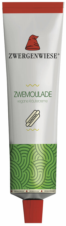 Eine Tube mit der veganen Kräutercreme "Zwemoulade" von der Marke Zwergenwiese. Das Etikett zeigt eine rote Zwergenmütze und die Aufschrift "Zwemoulade - vegane Kräutercreme". Am unteren Rand der Tube befindet sich ein grünes, wellenförmiges Muster. Die Tube hat einen roten Verschluss. Diese vegane Kräutercreme eignet sich hervorragend als Aufstrich oder als Dip und bietet einen frischen, würzigen Geschmack, ideal für Sandwiches und Gemüsegerichte.