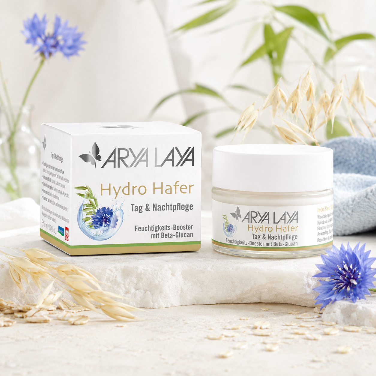 ARYA LAYA Hydro Hafer Tag & Nachtpflege mit Hafer und Kornblume in natürlicher Pflegekulisse